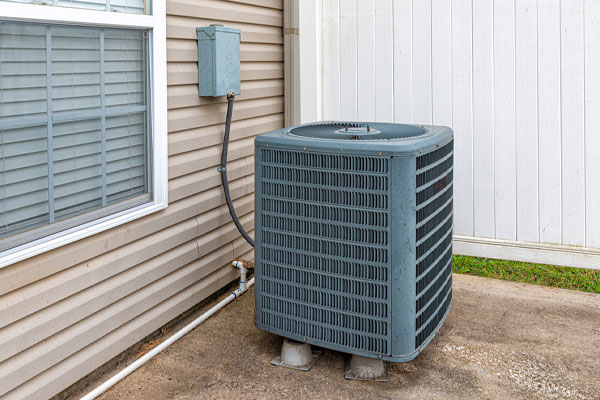 Outdoor AC condenser unit installed in an Aurora residential yard