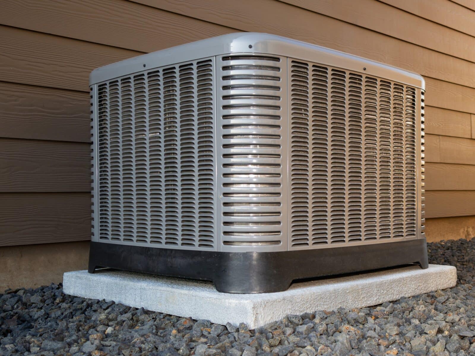 Technician inspecting an outdoor AC condenser unit