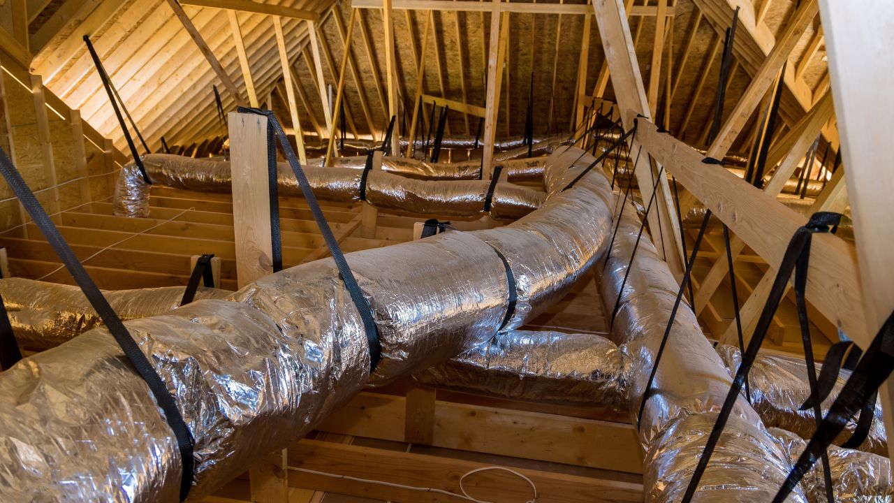 Attic ductwork in an Aurora home — a common source of rattling and popping noises carried through vents